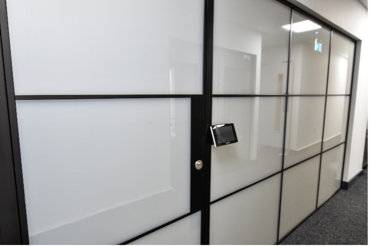 commercial meeting room viewed from outside, privacy glass in opaque state