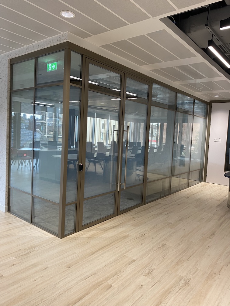 banded switchable glass partitioning in an office meeting room, 'on' position