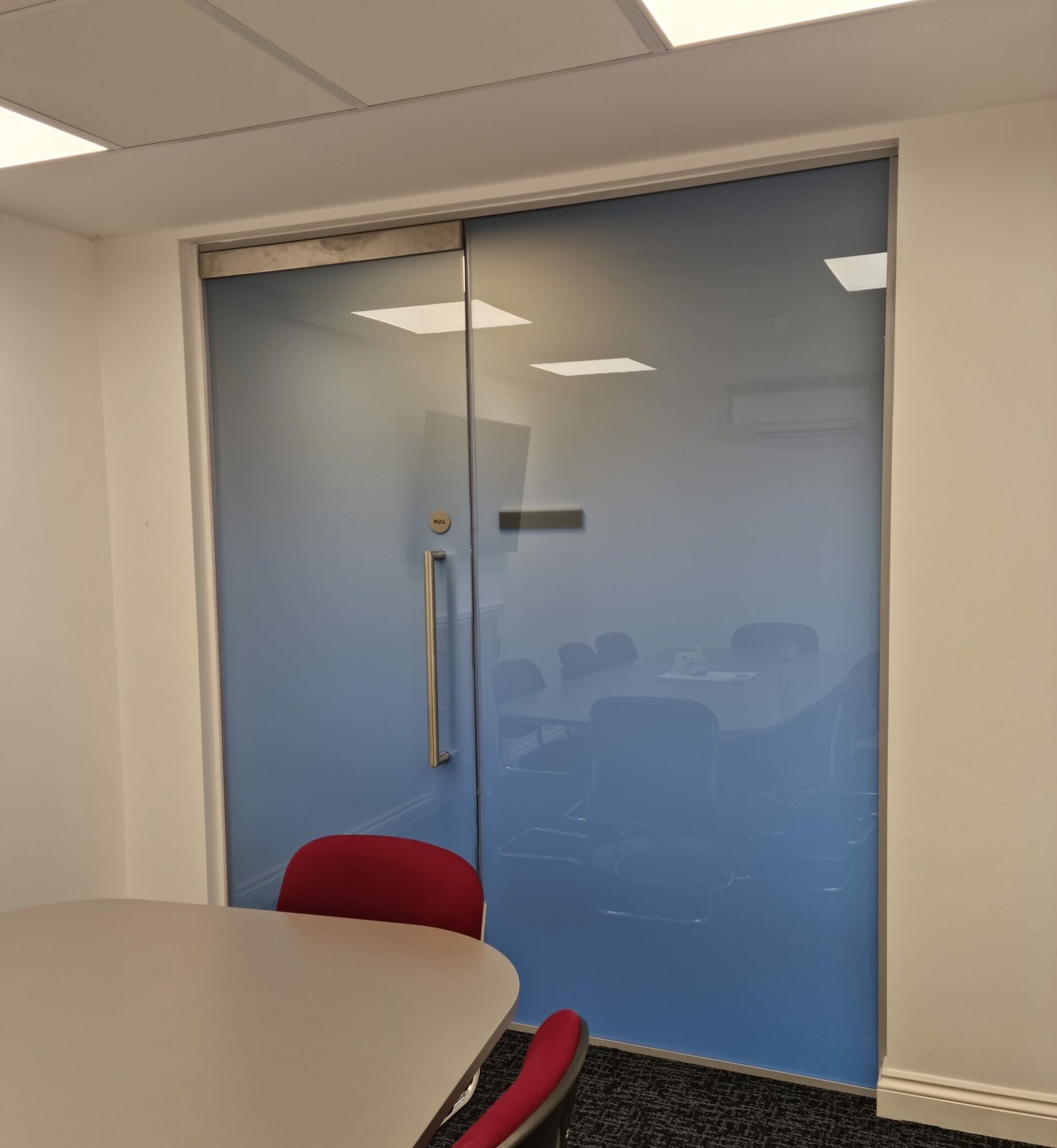 a compact meeting room in Bromsgrove England makes use of privacy smart glass to provide instant privacy to clients.