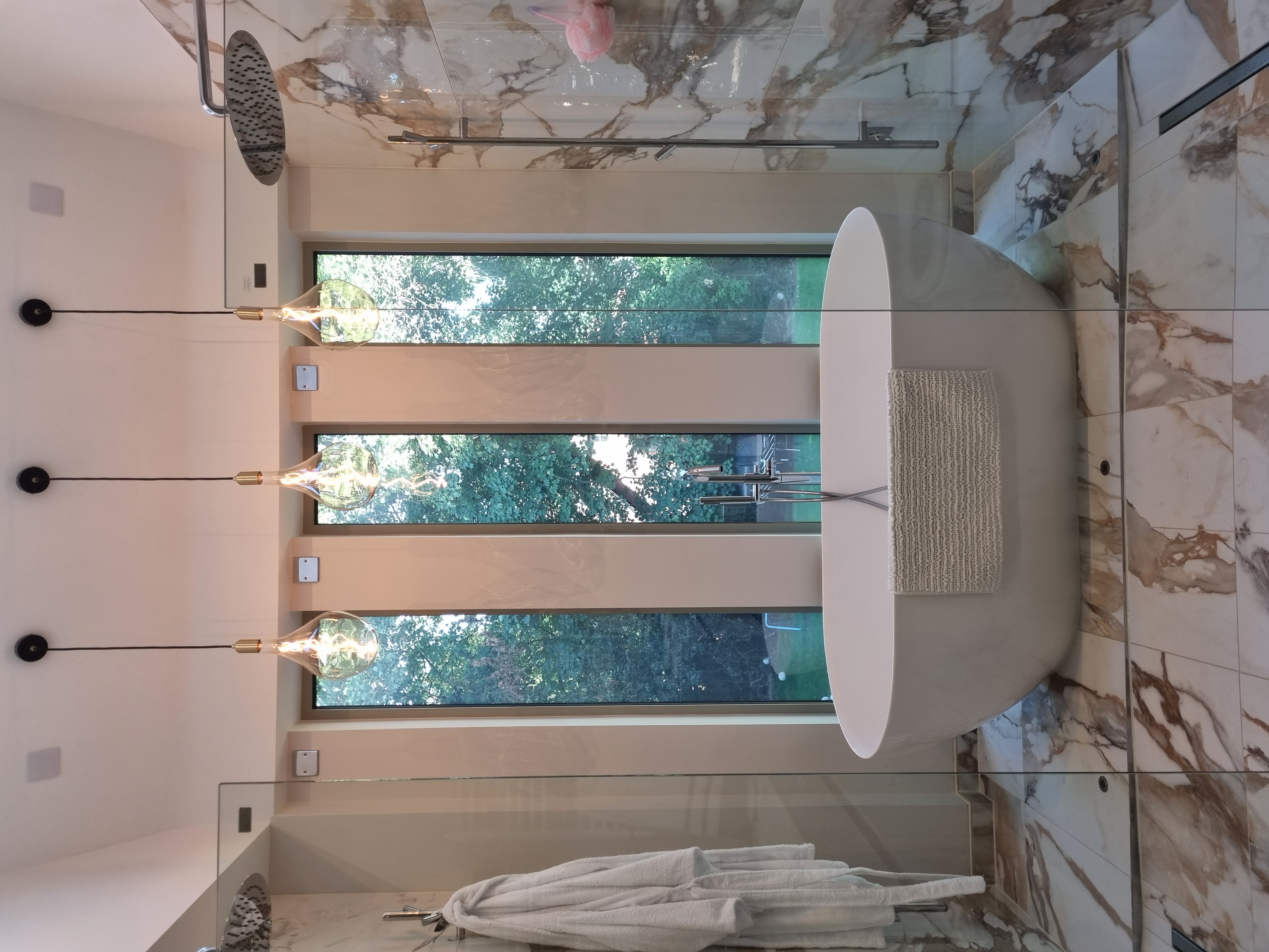 Instant privacy is made possible in both bathrooms of this modern house located in Oxfordshire, England, thanks to the use of privacy smart glass