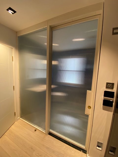 Sliding bathroom doors with switchable glass offer flexible privacy and natural light.