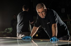 A Smartglass employee testing a panel of switchable glass